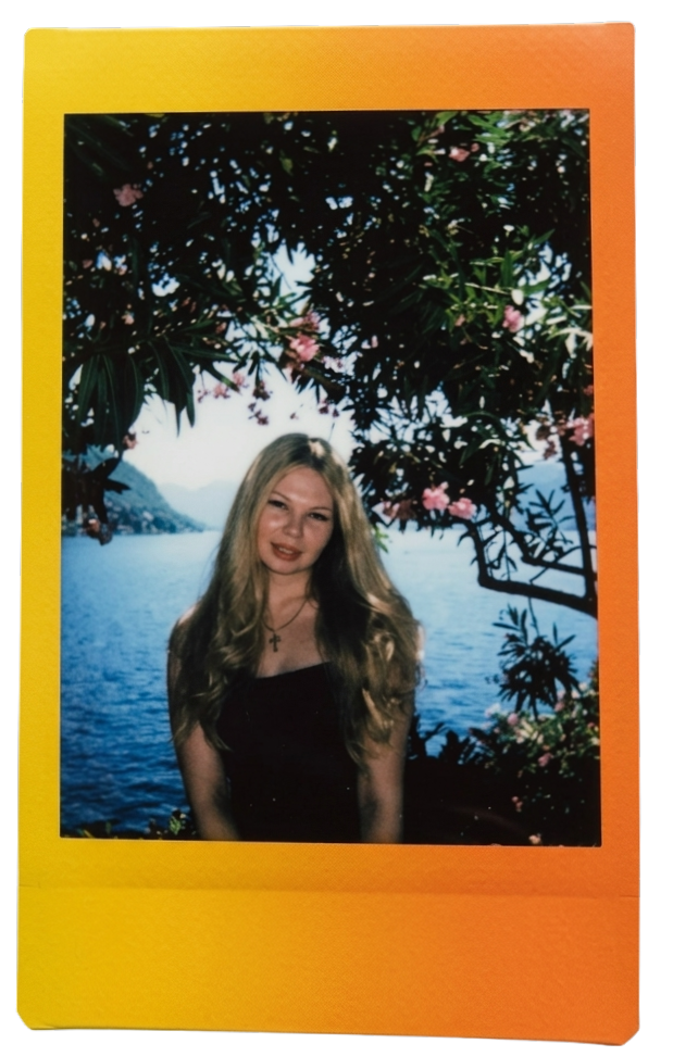 Anastasiia by the lake among oleander flowers